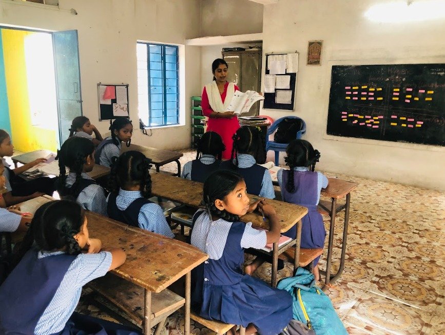 Teacher leading a classroom session with students at an ENLIFT Foundation education programme.