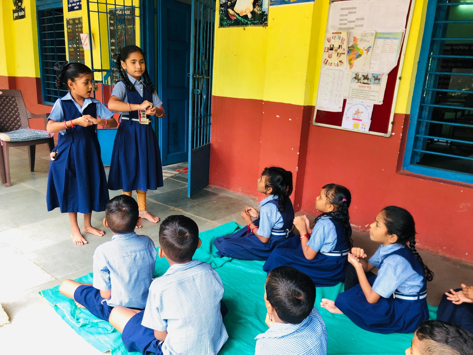 A smiling young student studying with a book, representing education and future potential.